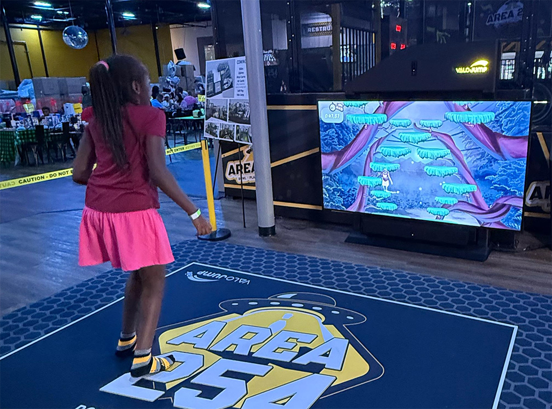 young girl on jumping pad with screen